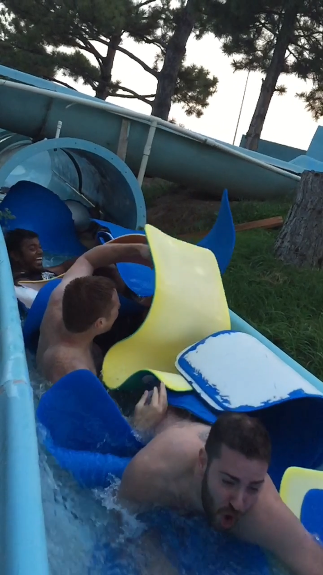 ThoughtLab team going down water slide