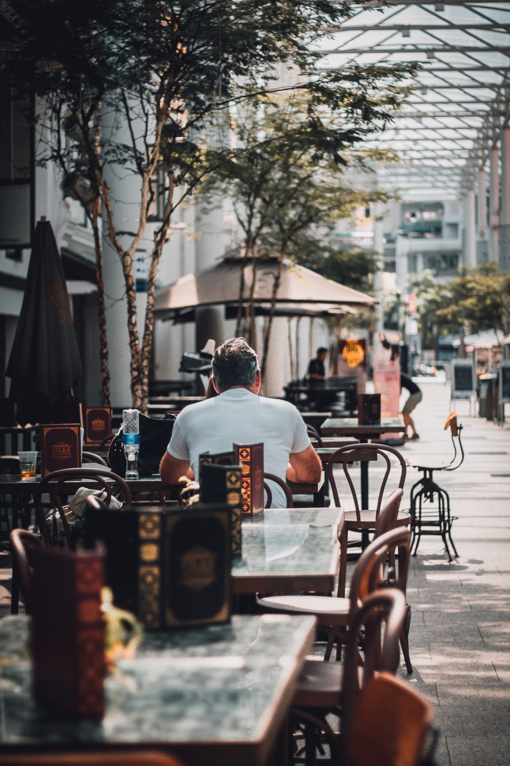men eating on outdoor cafe patio alone