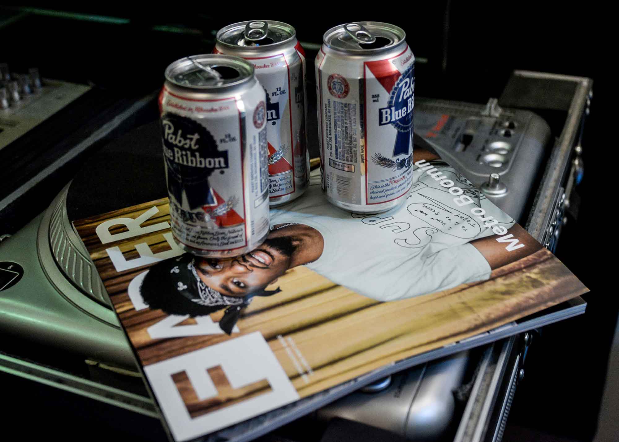 PBR cans sitting on top of a record case