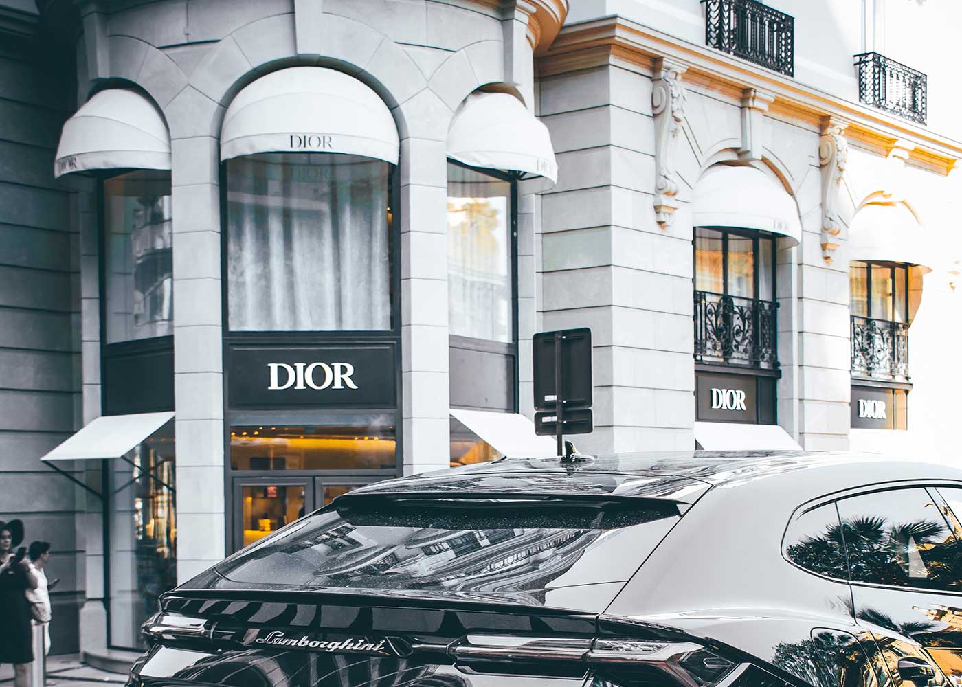 Luxury vehicle driving past Dior