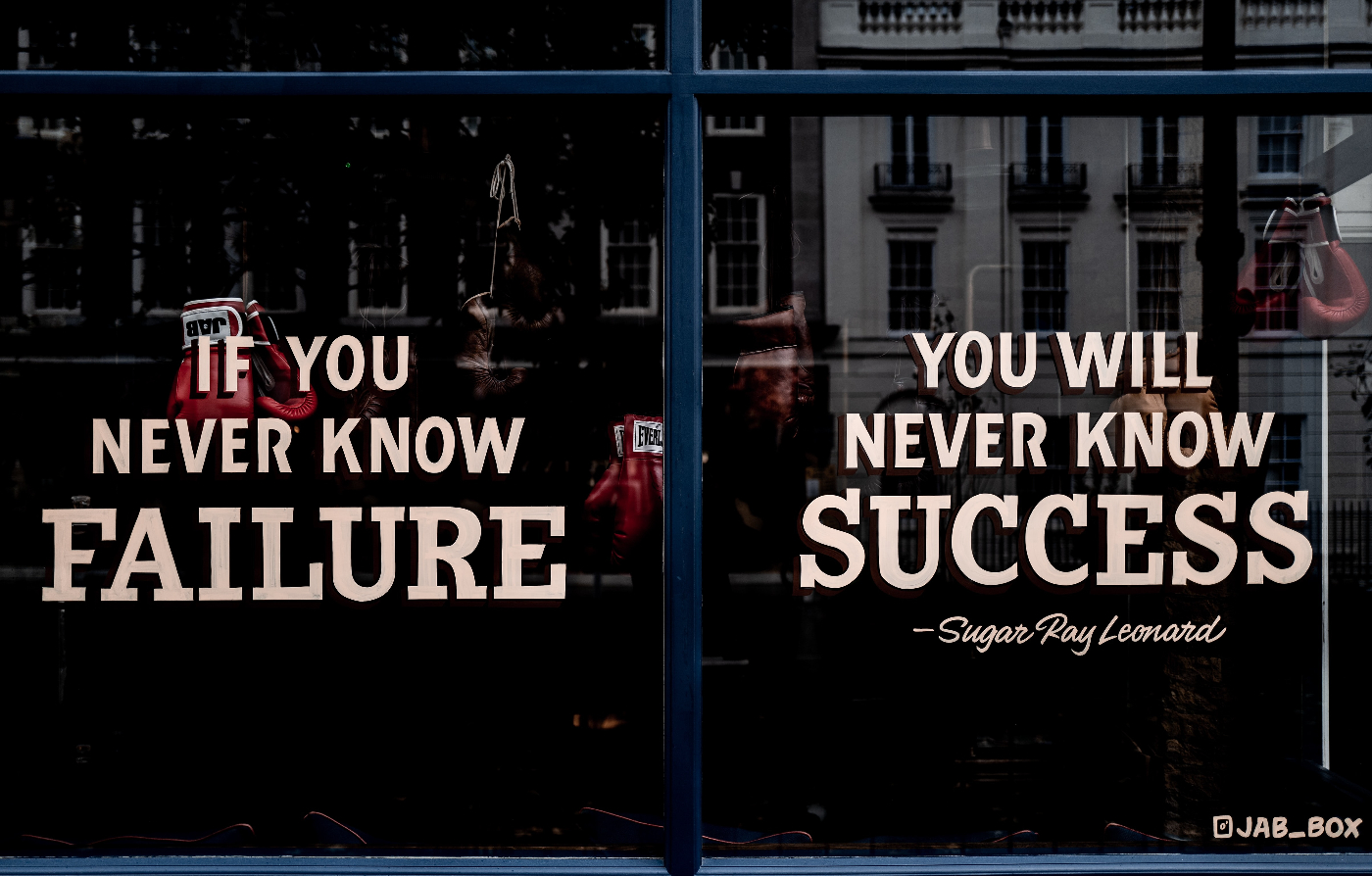 Window of a boxing gym reading; If you never know failure, you will never know success