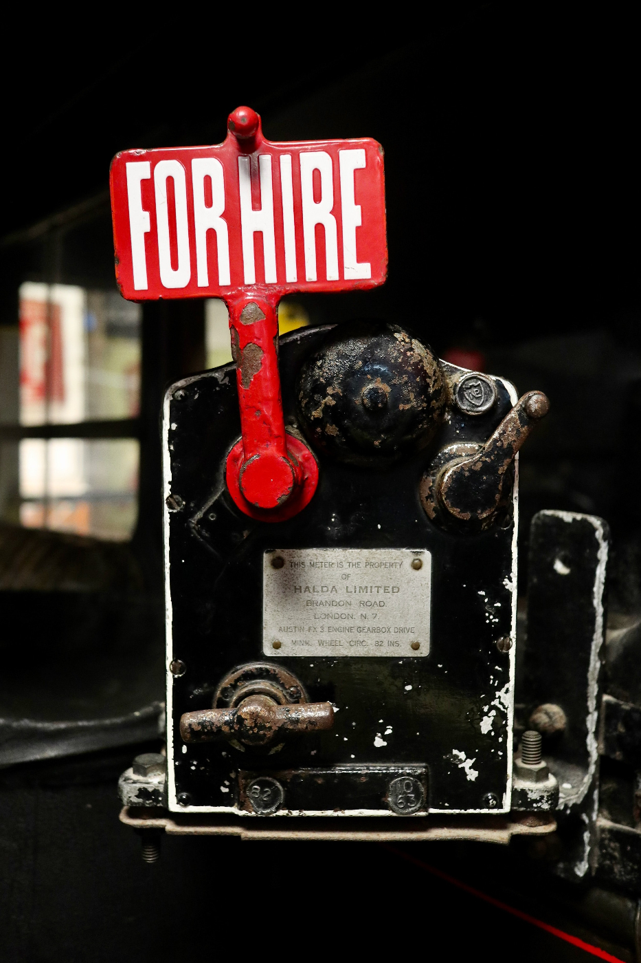 An old taxi meter with the red for hire sign up