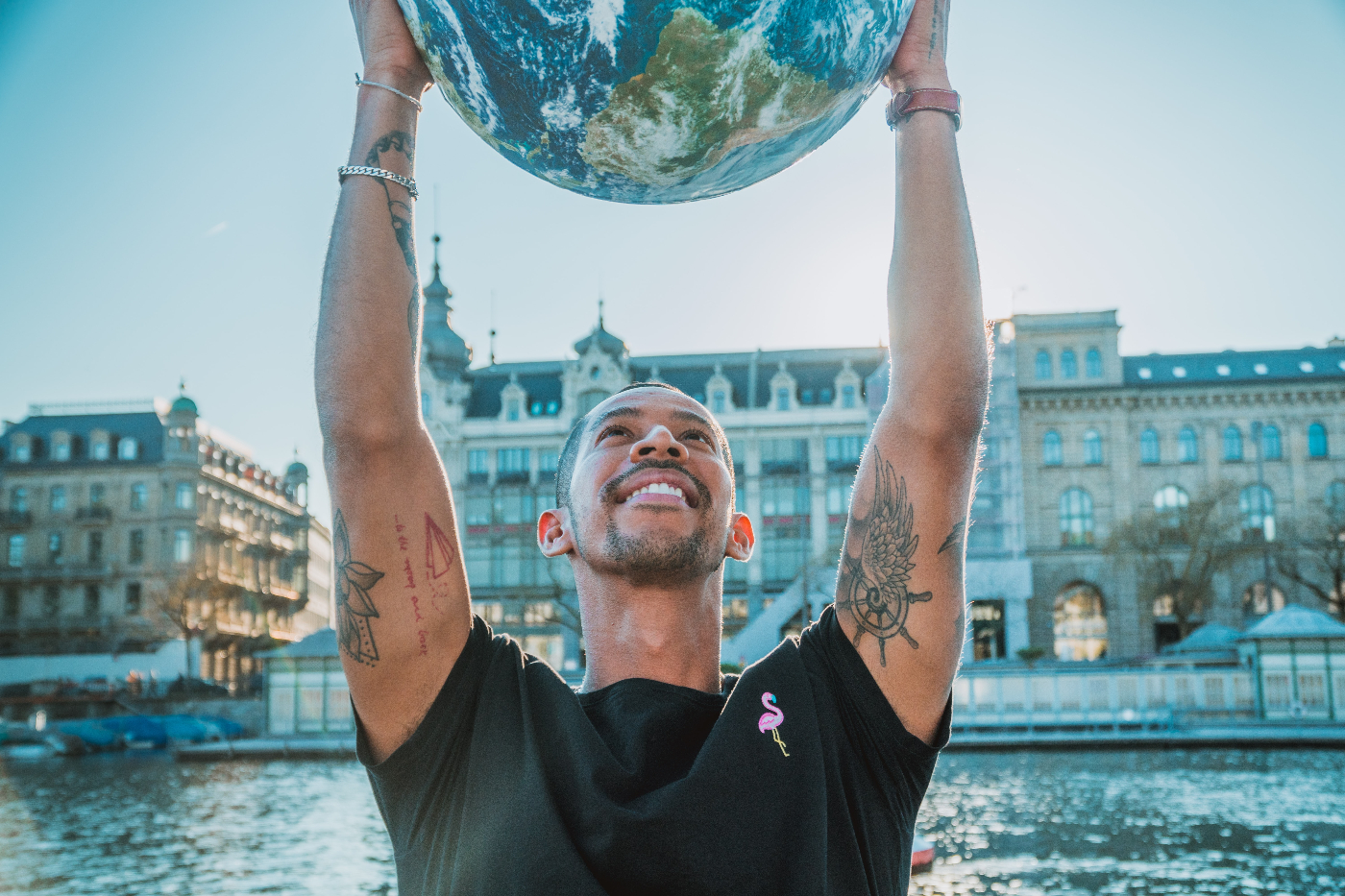 A man holidng a globe above his head