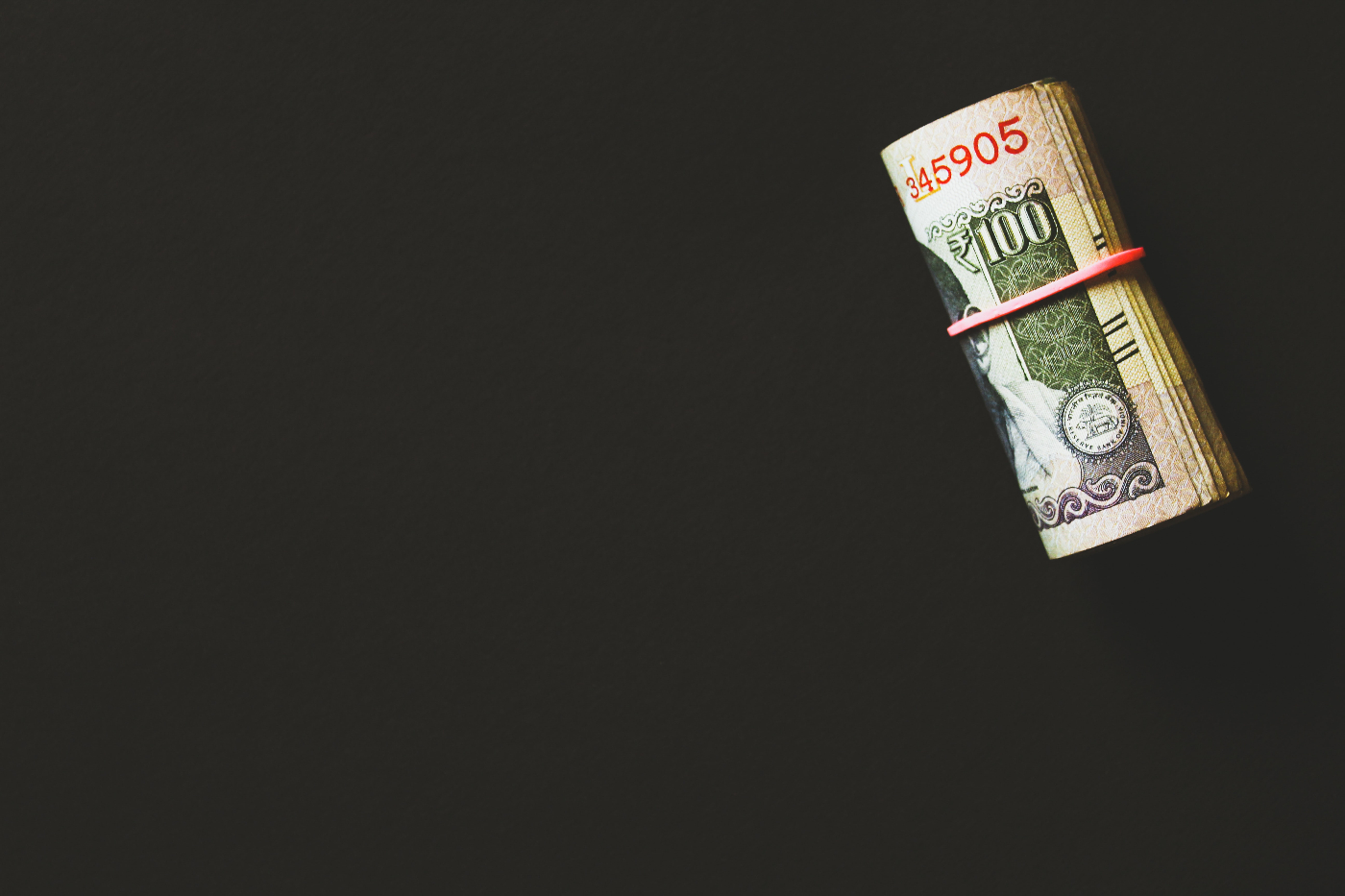 A tight roll of $100 dollar bills.