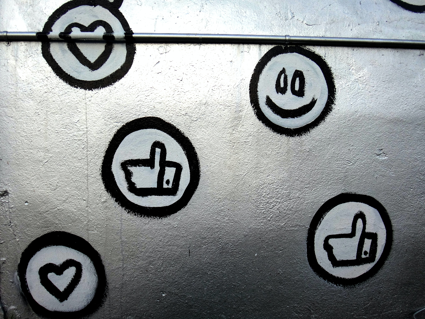 Social media symbopls painted on a silver wall
