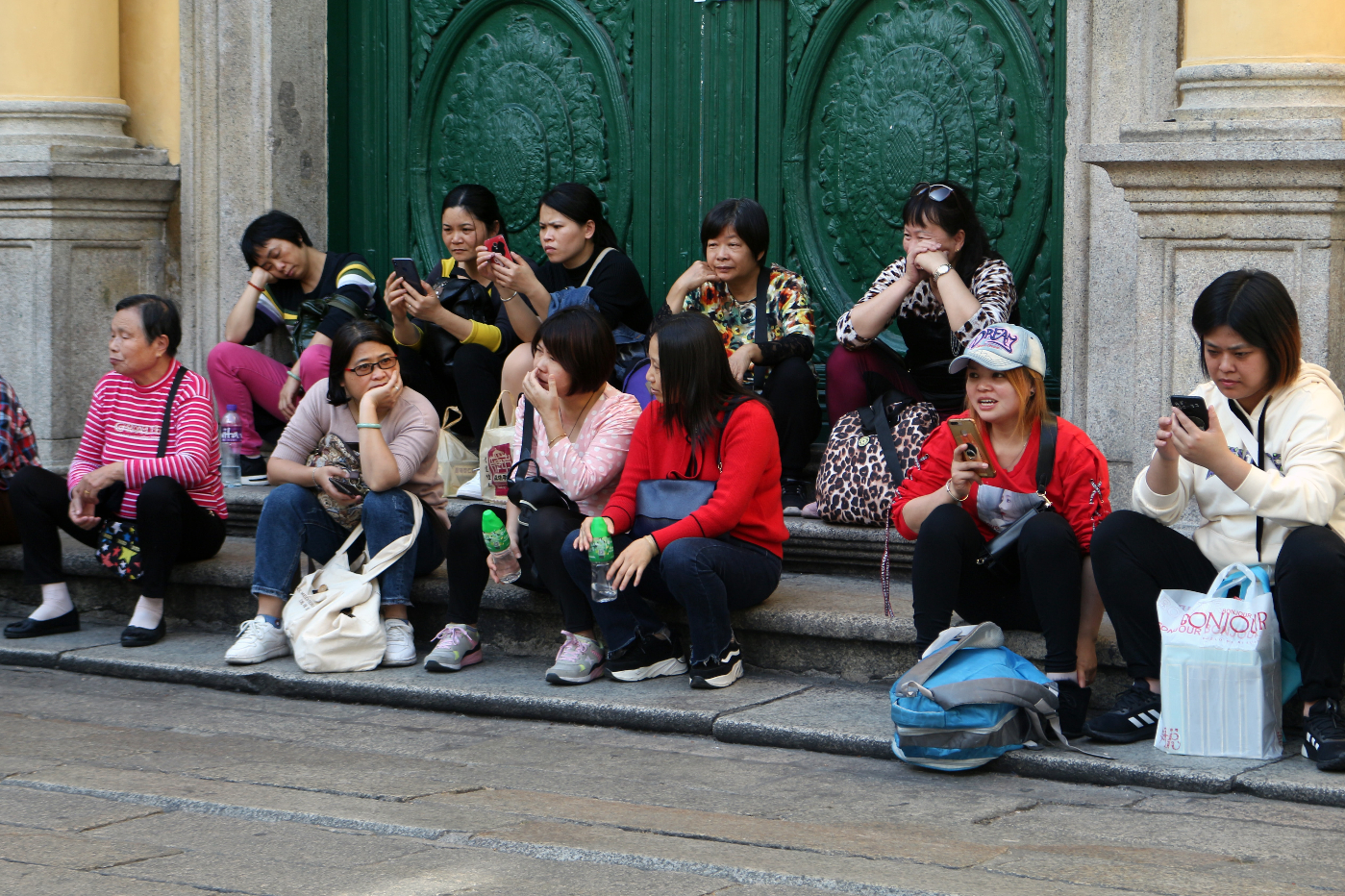 A group of women sitting on stairs