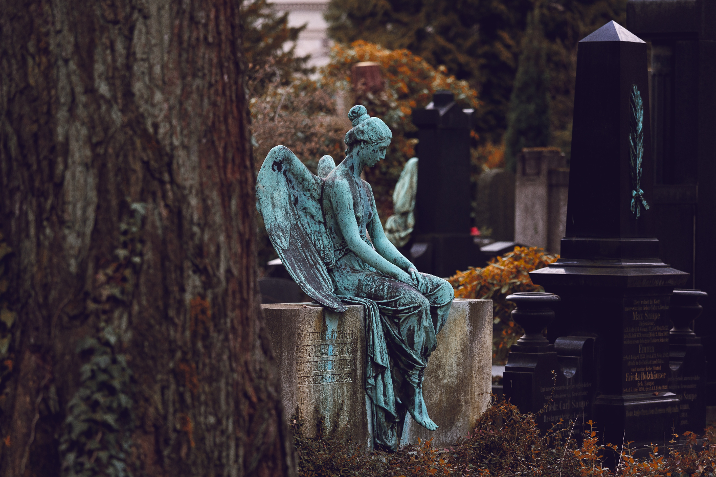 am angel sitting on a gravestone