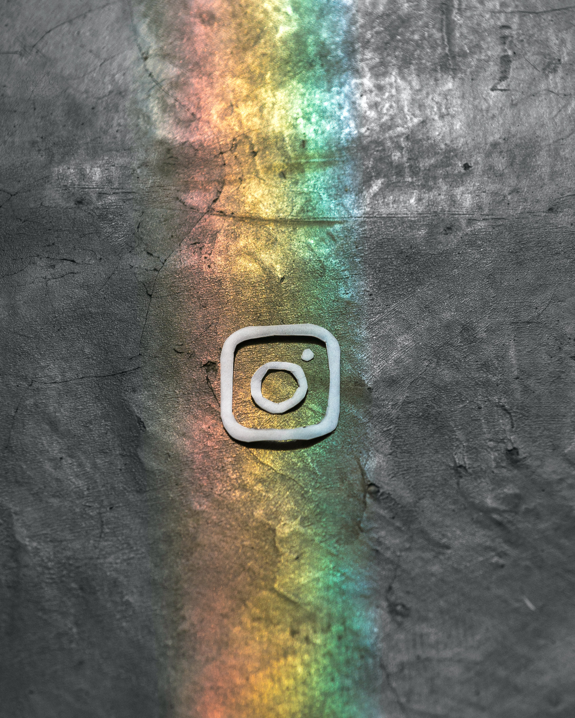 the Instagram logo on a slight rainbow wall