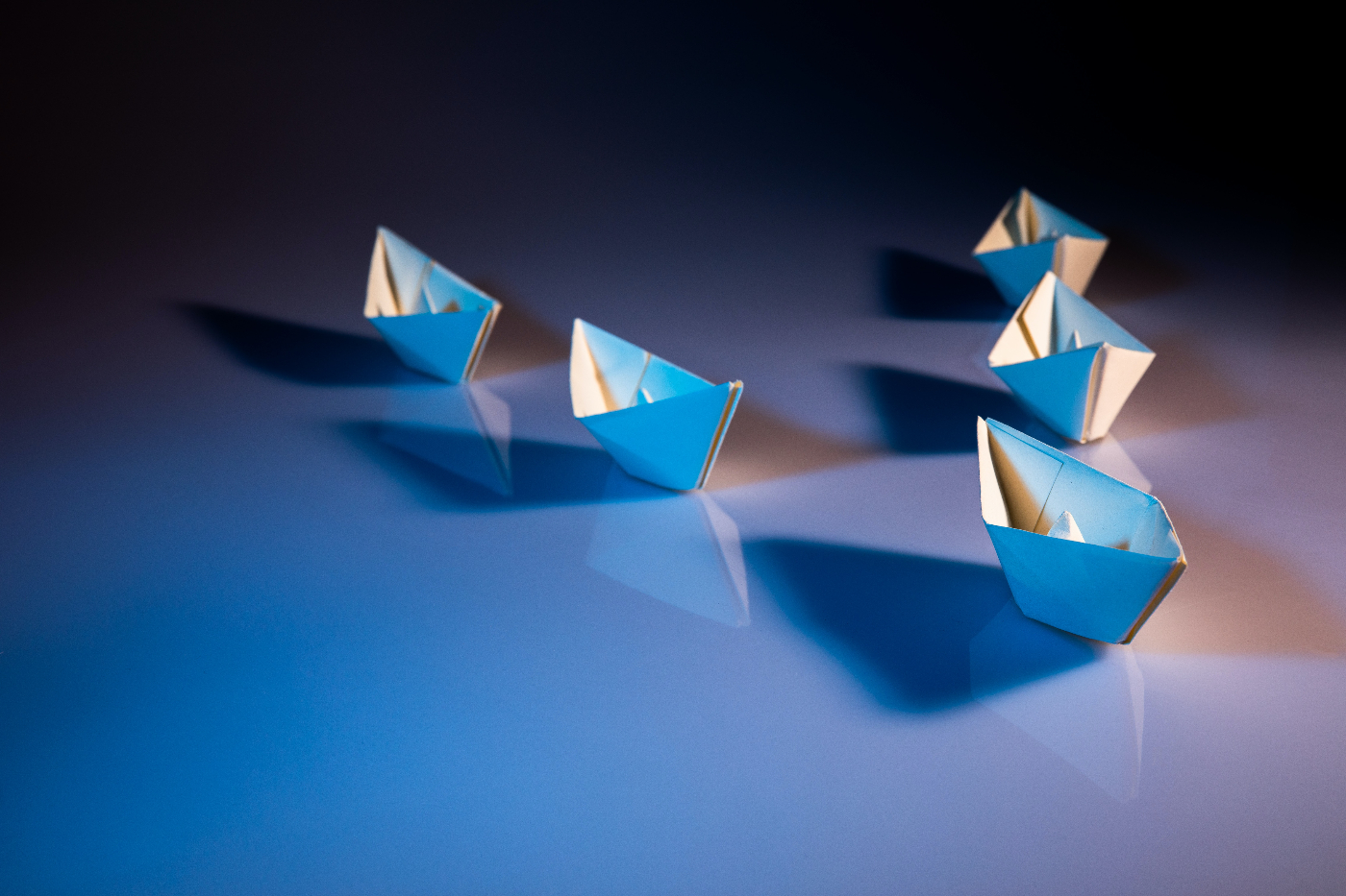 Five blue paper boats