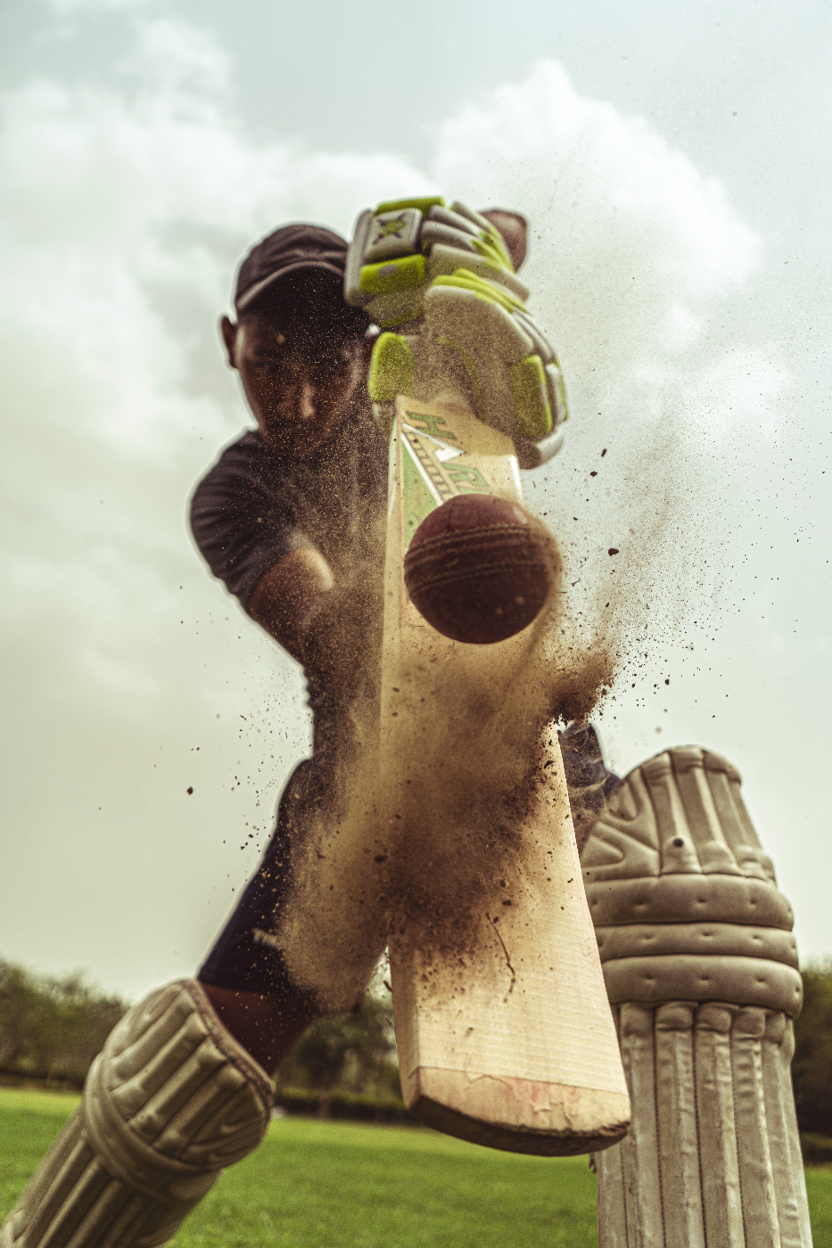 a cricket playing hitting a ball