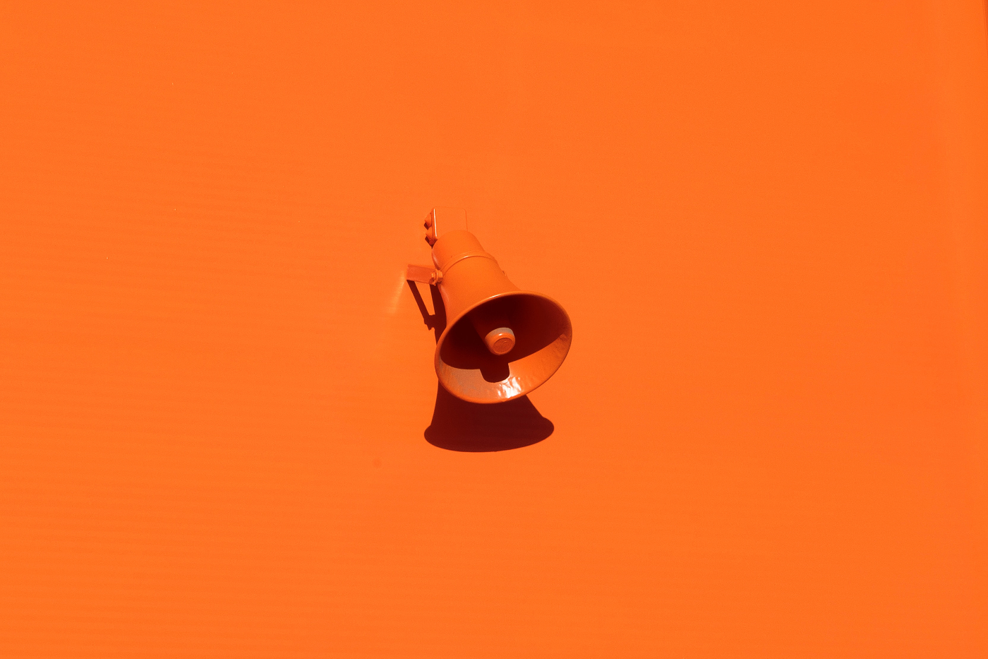 an orange bullhorn and an orange background