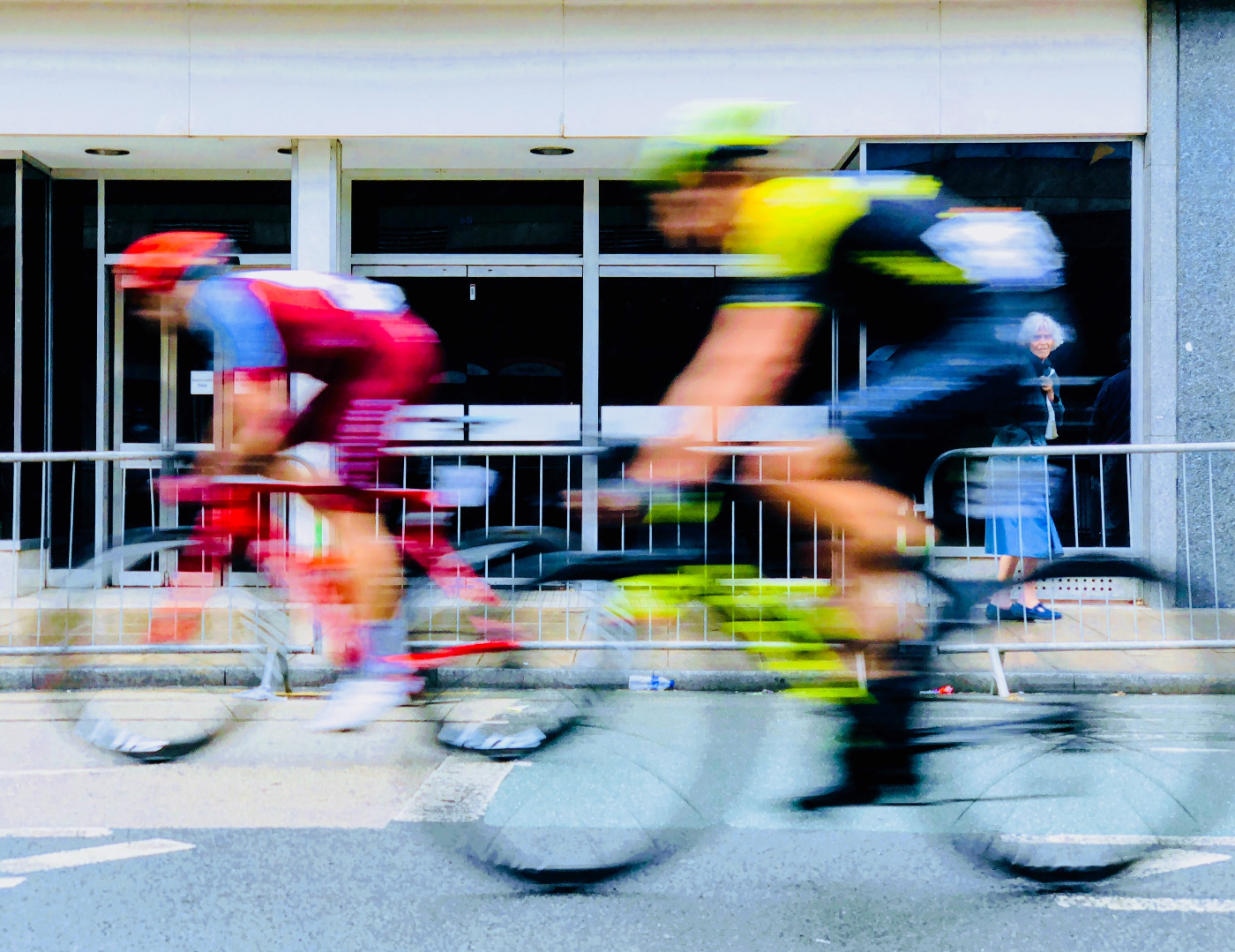 Two bike racers bluring by the camera