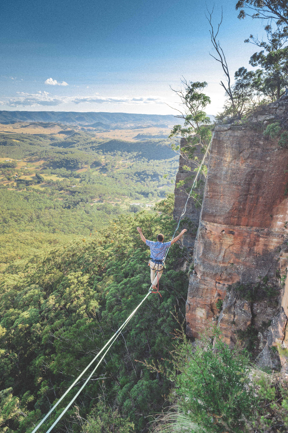 a amn on a tight rope crossing a cavern
