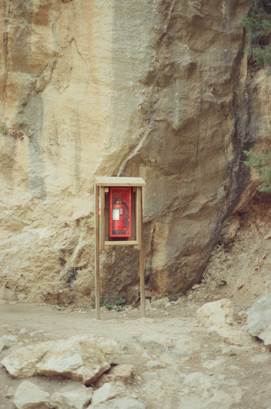 a fire extinguisher in a glass case in the middle of nowhere