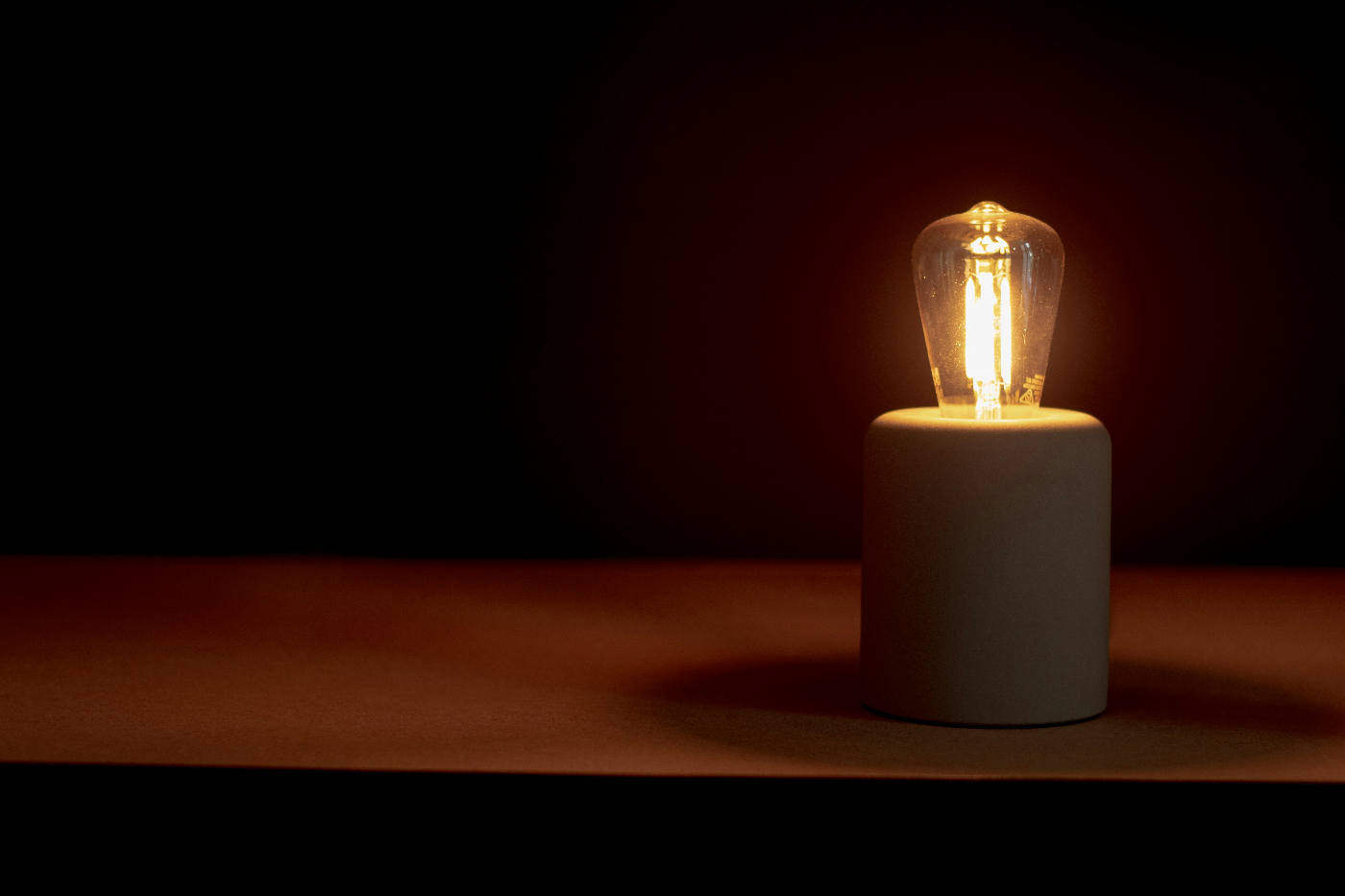 a lightbulb in a stand on a shelf
