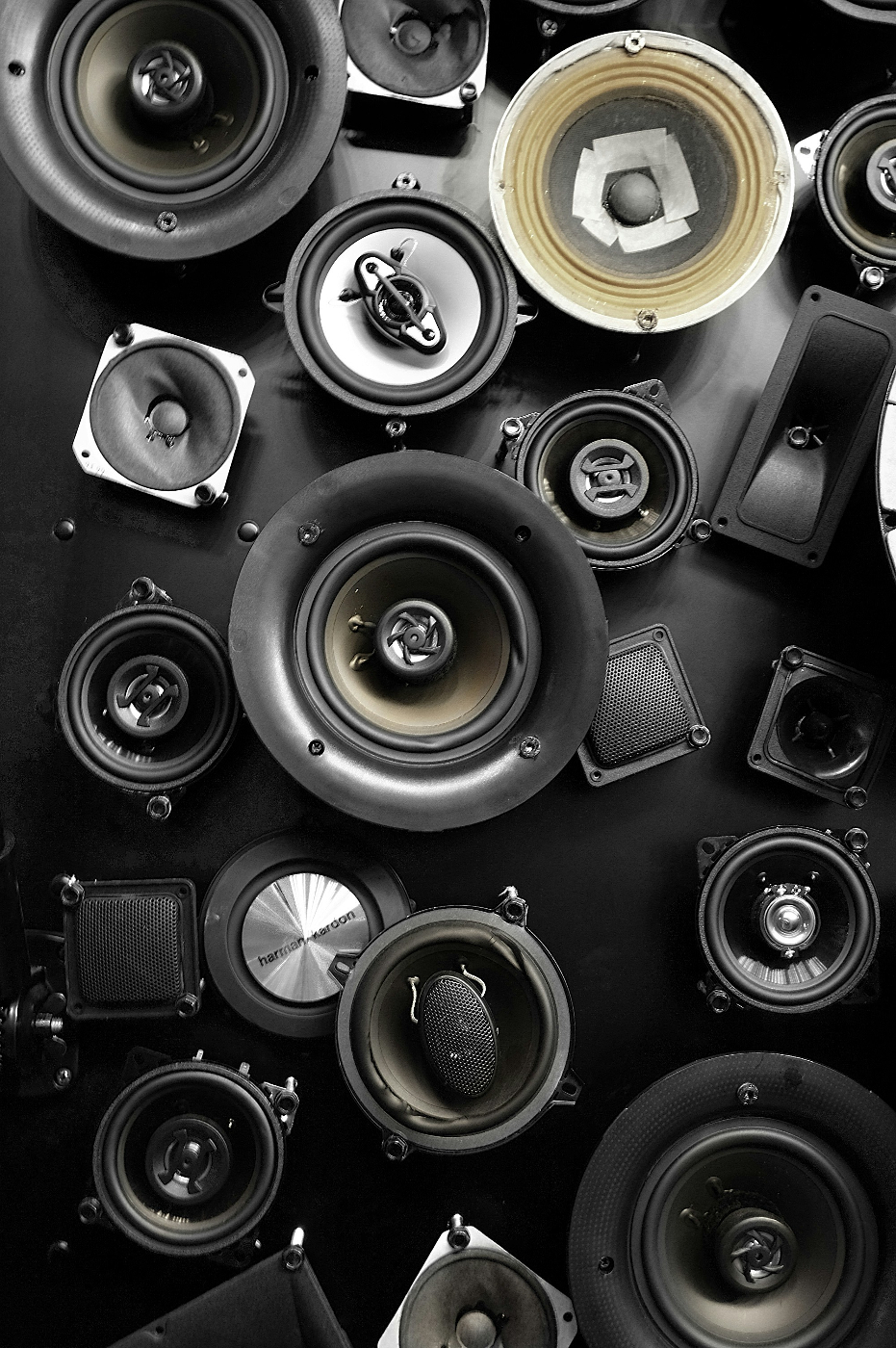 a bunch of speakers set out on a table