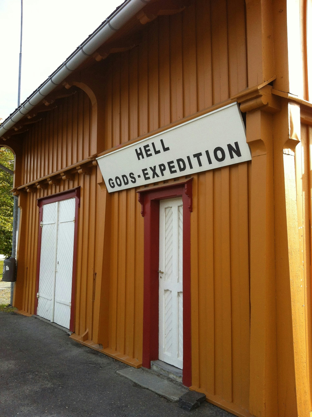 A brown building with a sign over the door reading Hell Gods Expedition