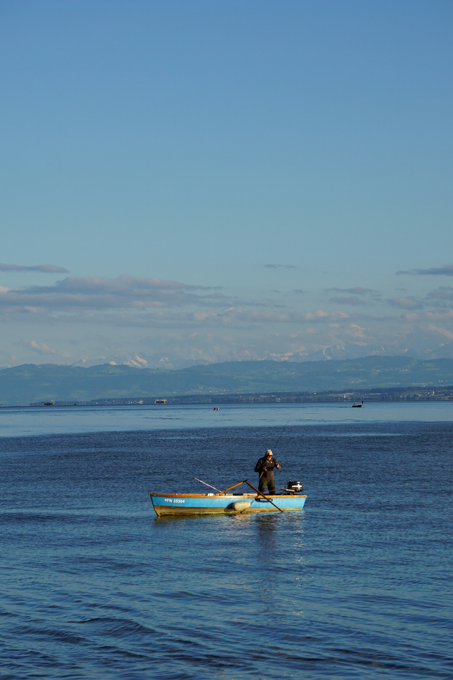 A man in a small boat fishing