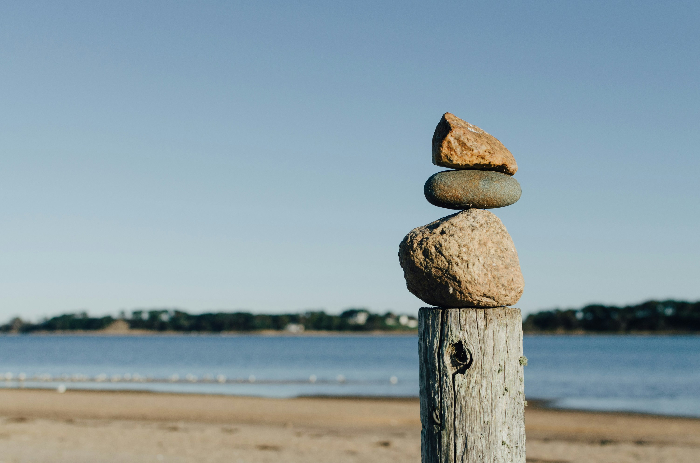 Three stones balanced atop a wood post
