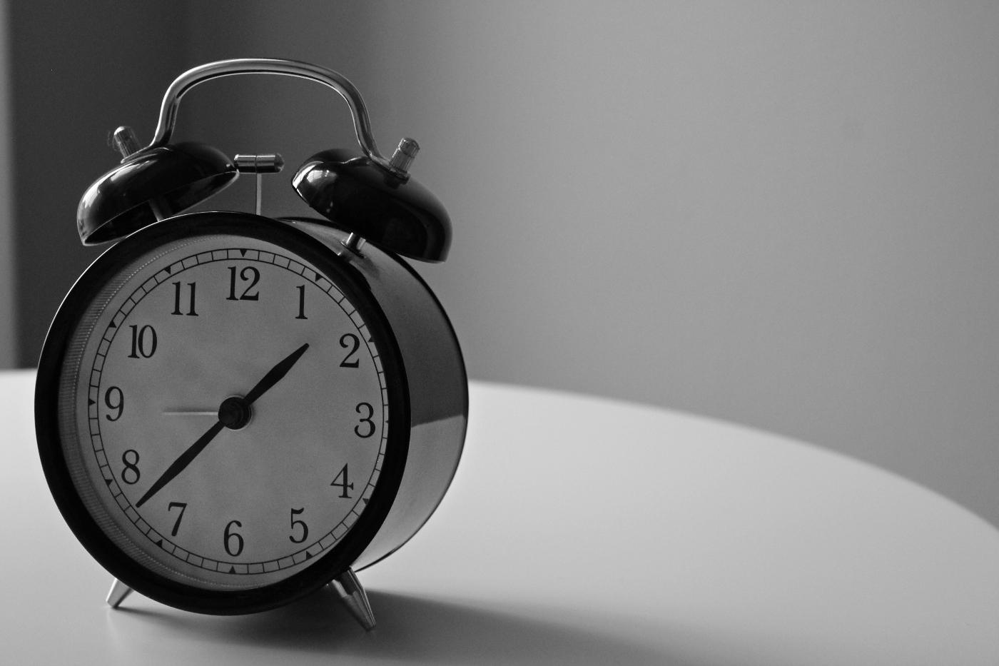 A black and white image of an old tome alarm clock