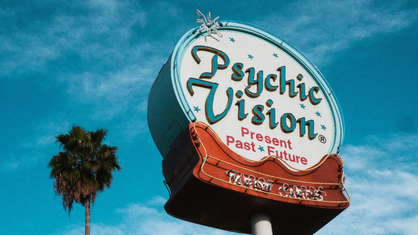 A circular neon sign that reads Psychic Vision Past, Present and Future