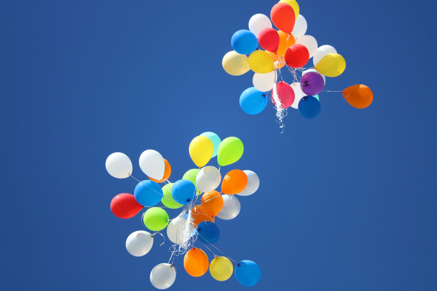 Two bunches of balloons floating free