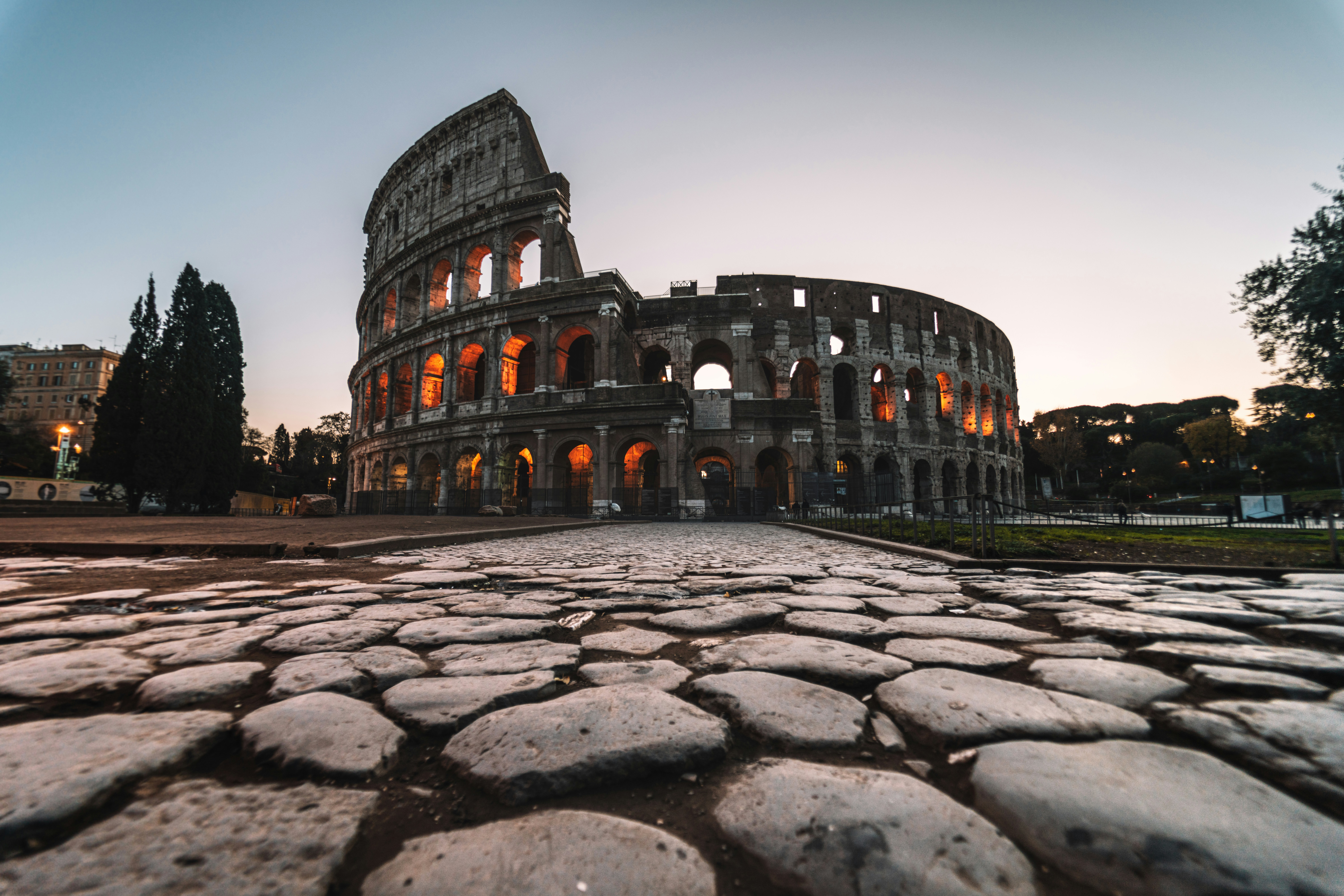 The Colosseum and the stone road leading to it at dusk