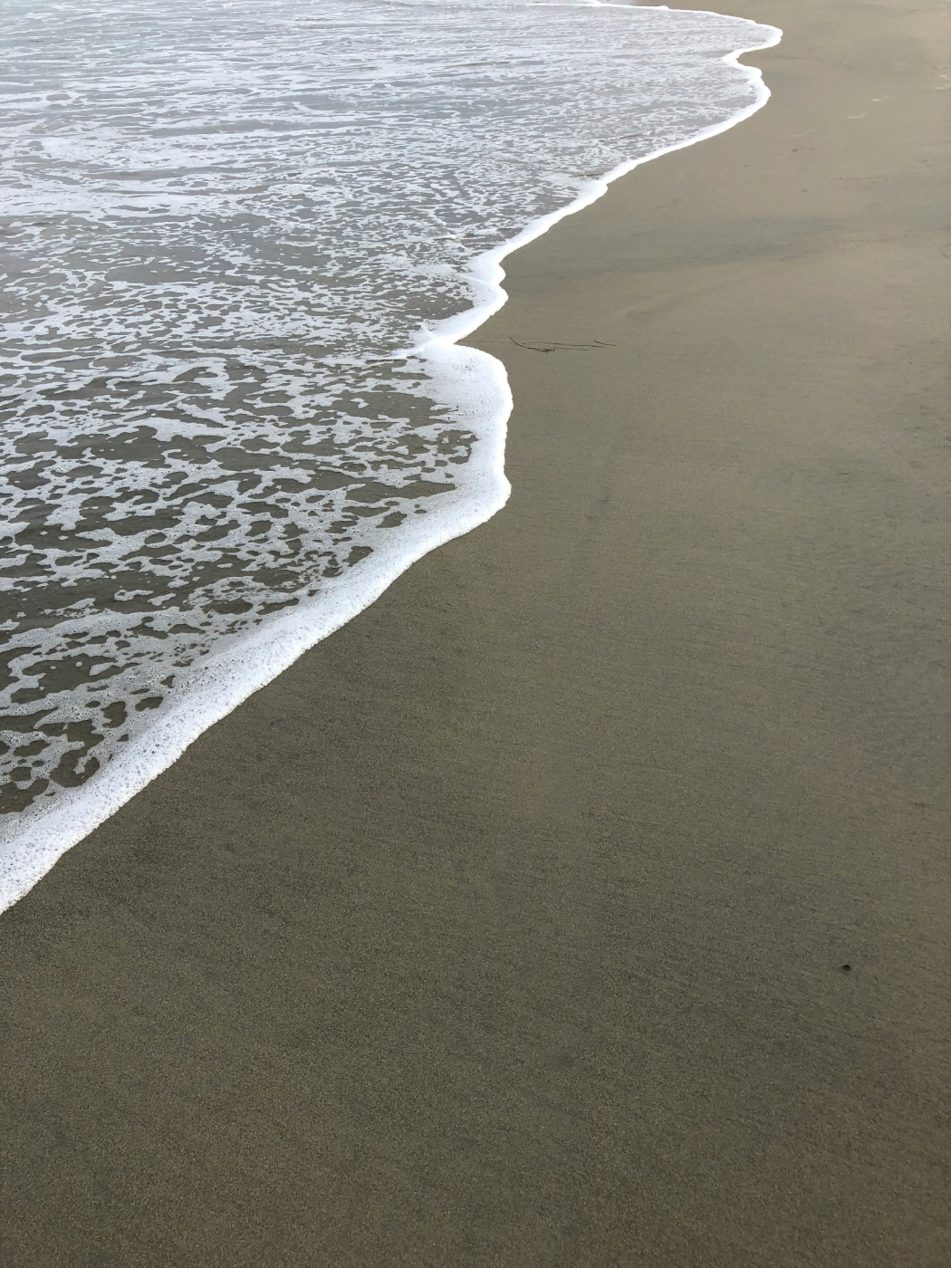 Ocean water rolling up on the beach