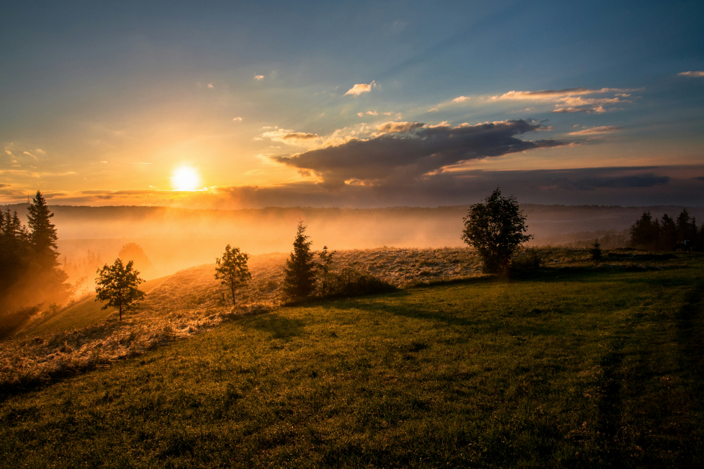 The sun rising over a misty landscape