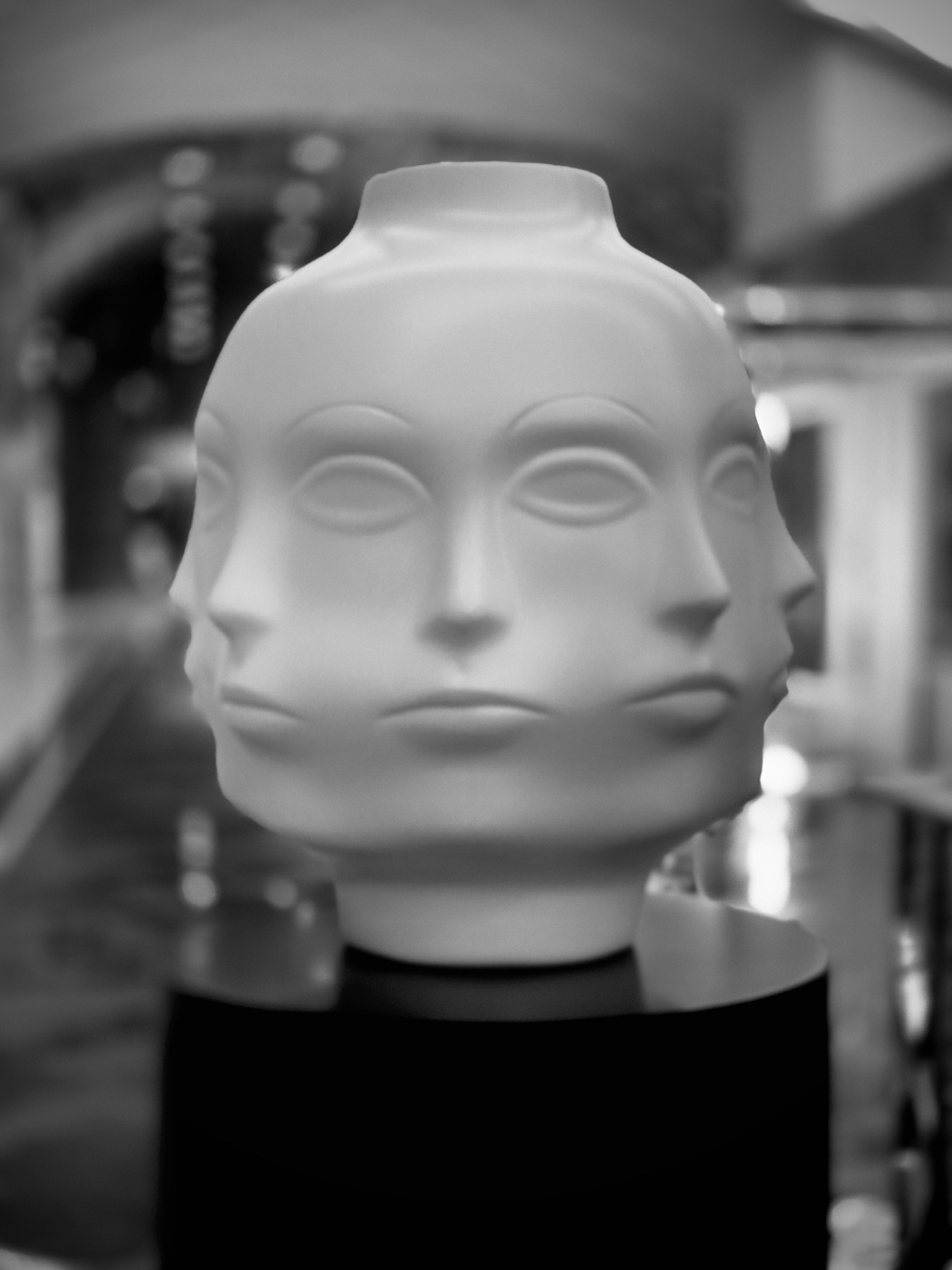 A statue of a woman's head with the face repeated around it