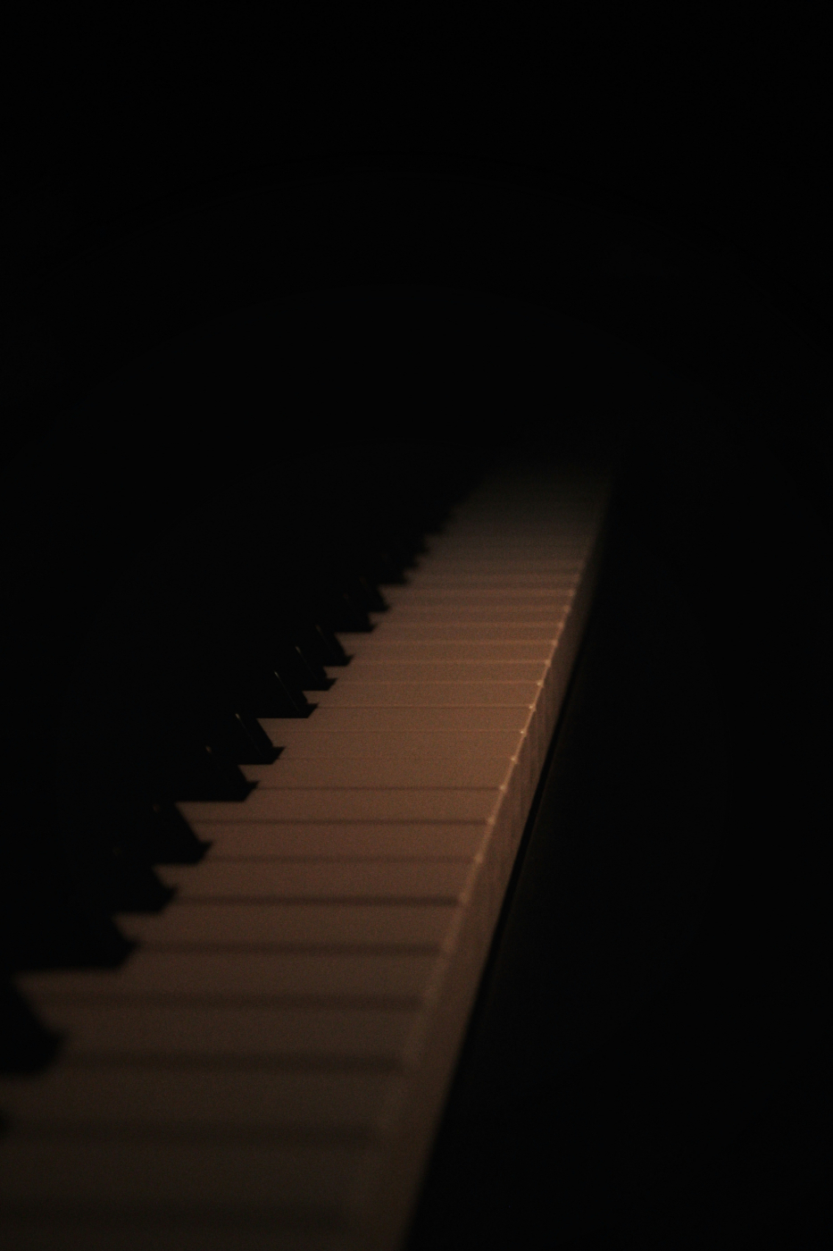 a Piano keyboard in low  light