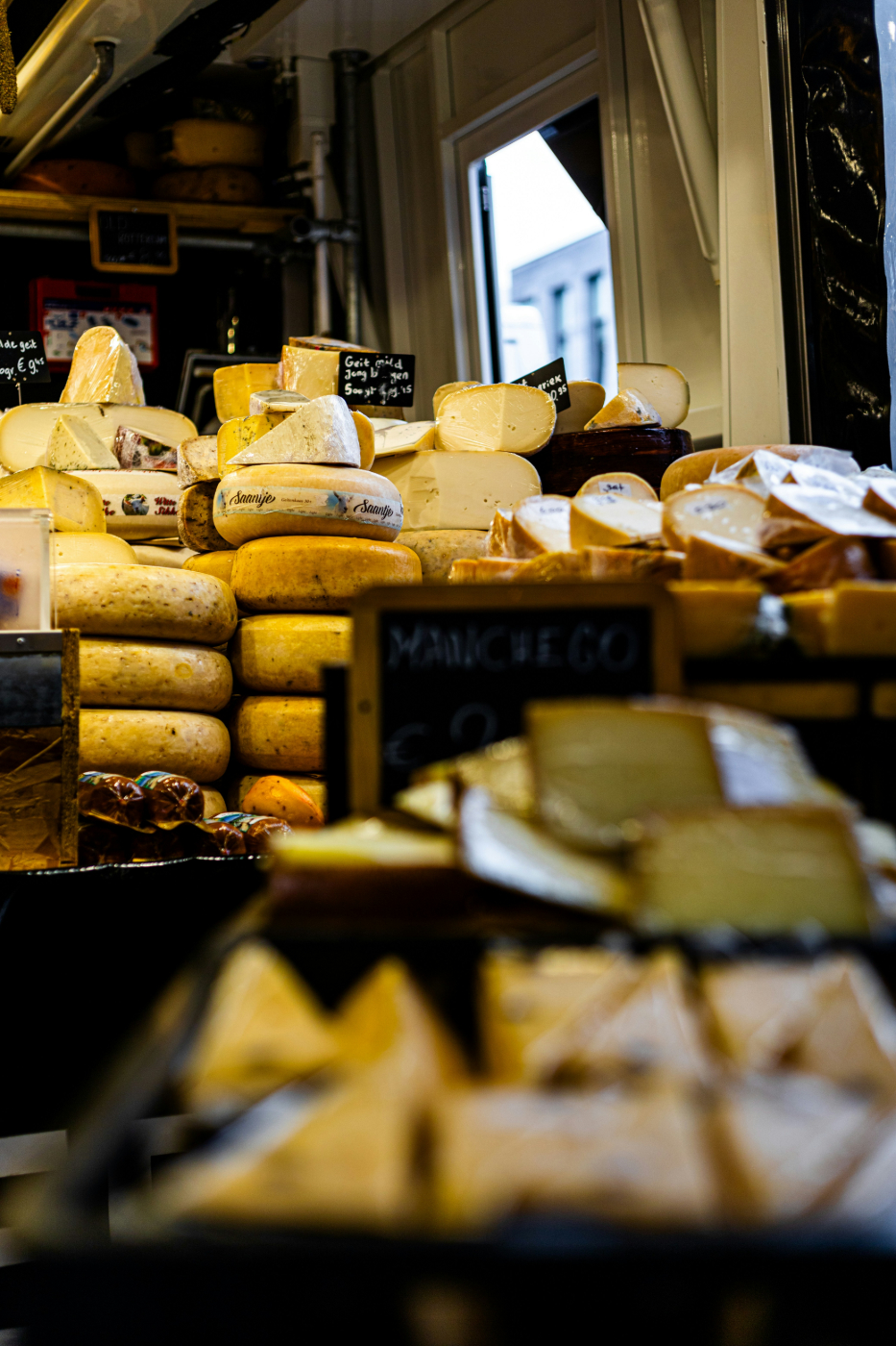  cheese shop displaying hundreds of different cheeses