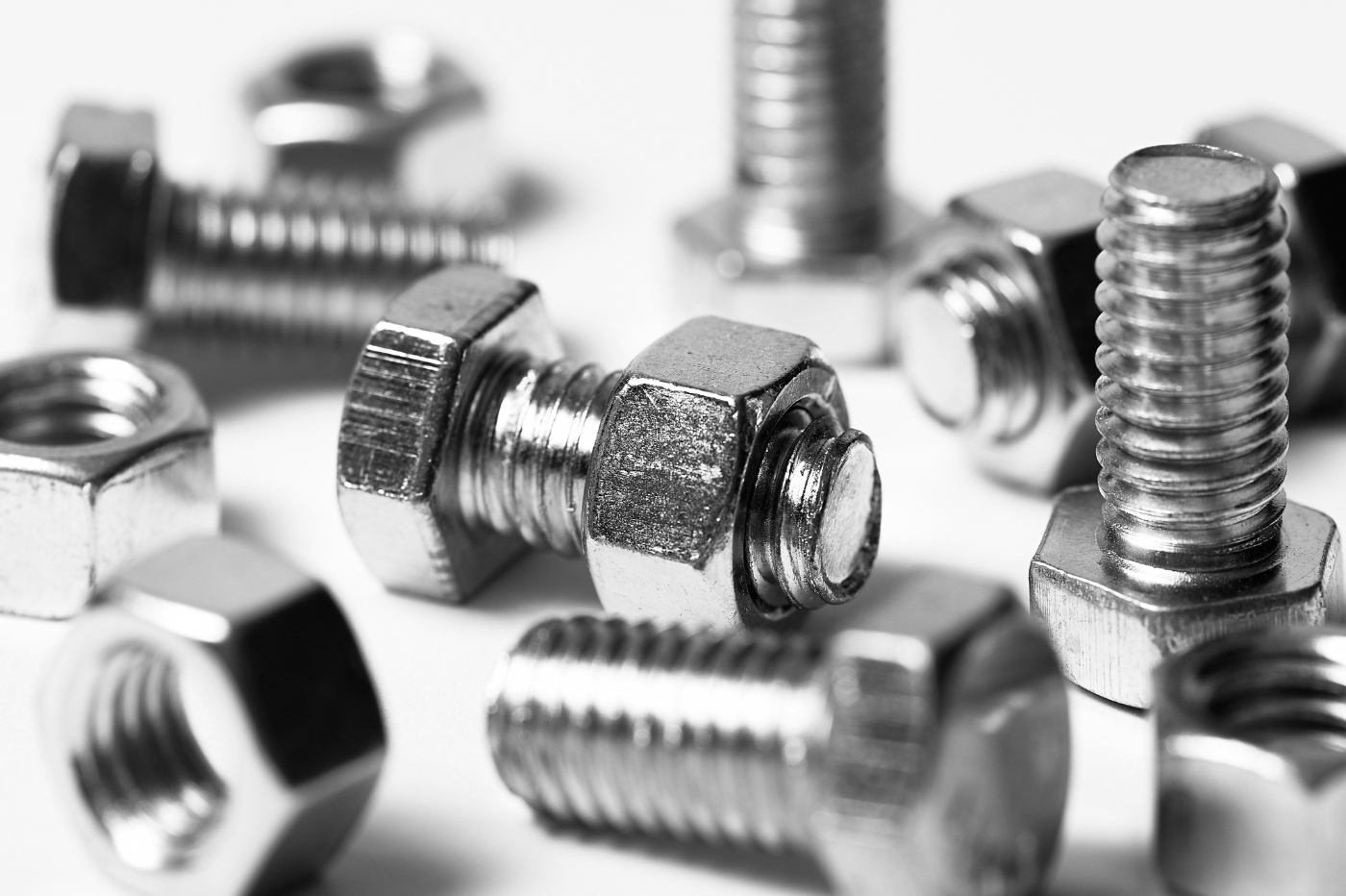 Silver nuts and bolts on a white background