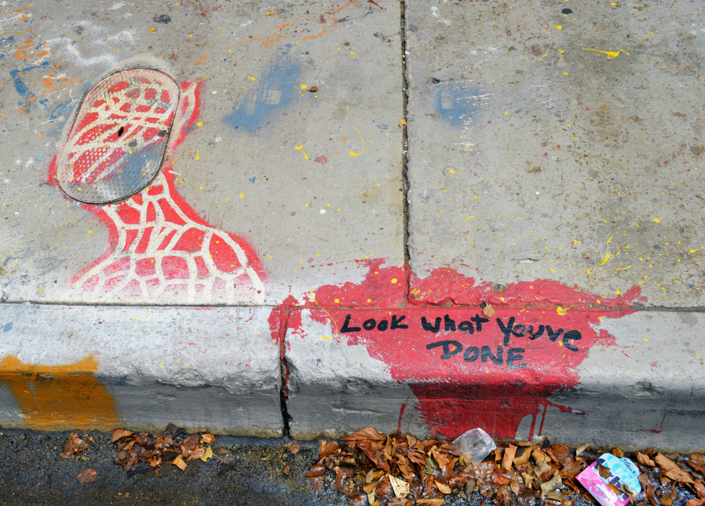 Graffiti on a wall reading Look What You Have Done