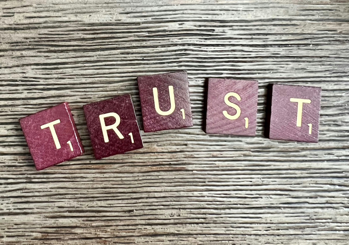 The word Trust spelled out in Scabble tiles