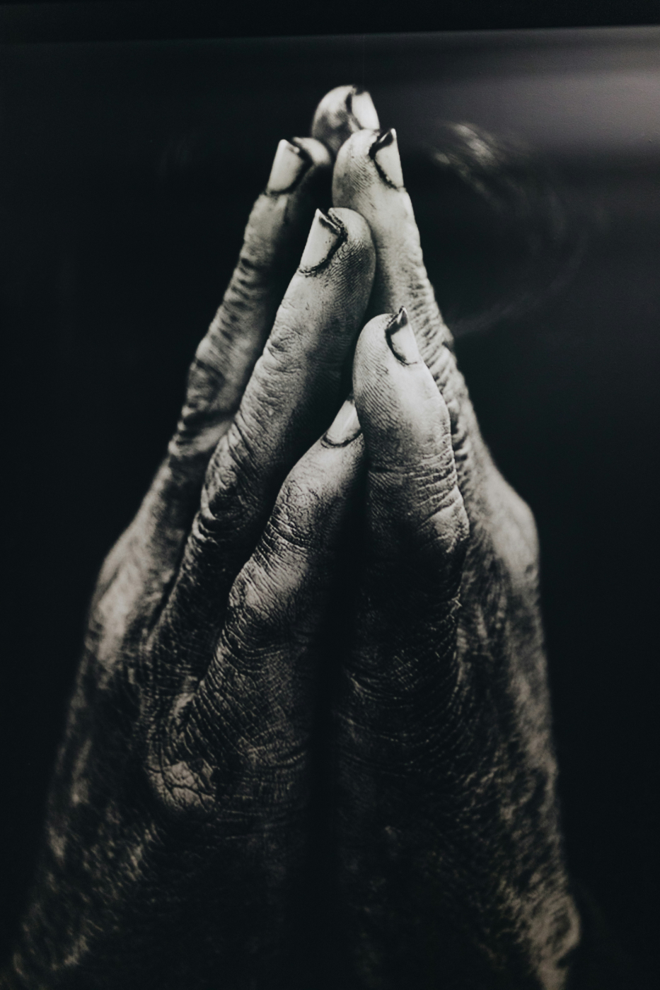 Dusty hands held in prayer