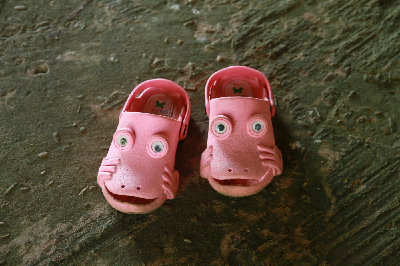 Pink rubber clogs with eyes and smiles