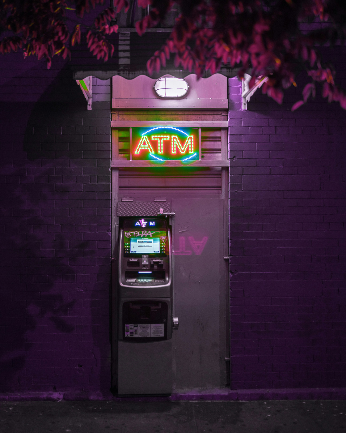 An ATM under purple light