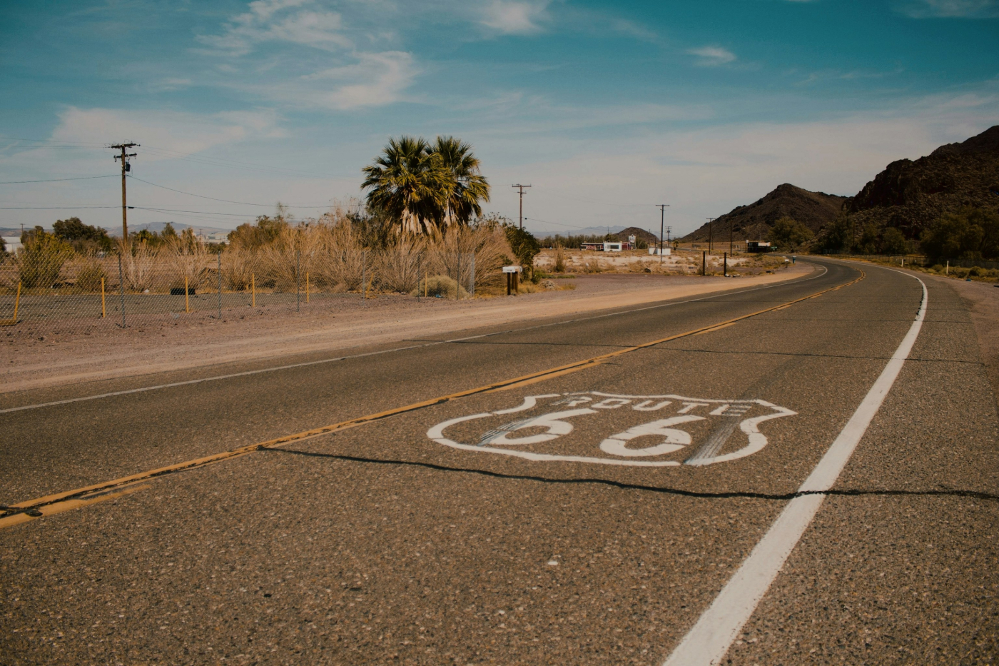 A stretch of road with the Route 66 emblem painted on it