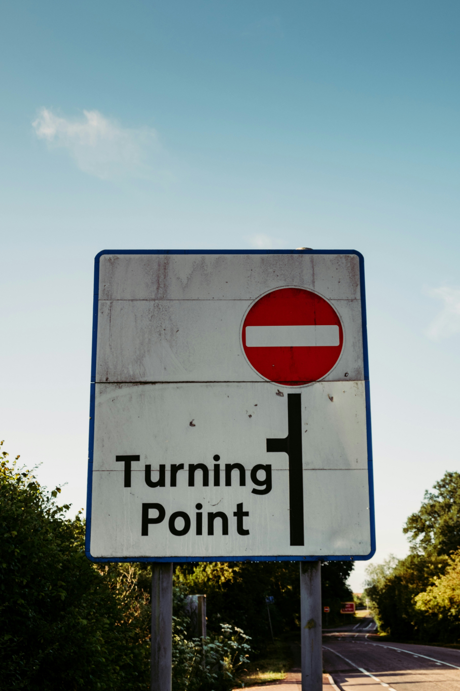 A street sign with a red circle and the words: Turning Point