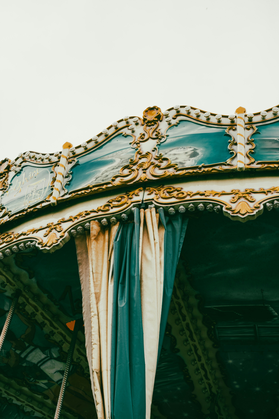 The curtains and filigree of a defunct carousel 