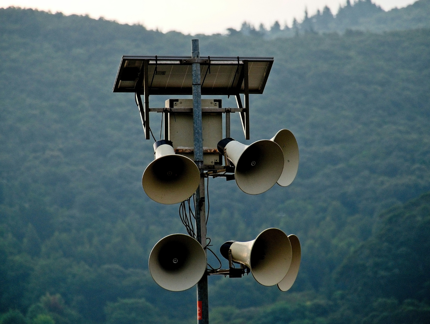 A makeshift communication tower with 6 bullhorns