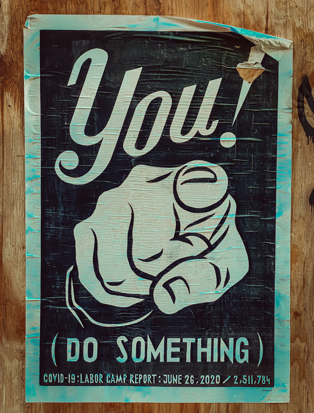 A wall poster with a finger pointing at the reader; You! (Do something)