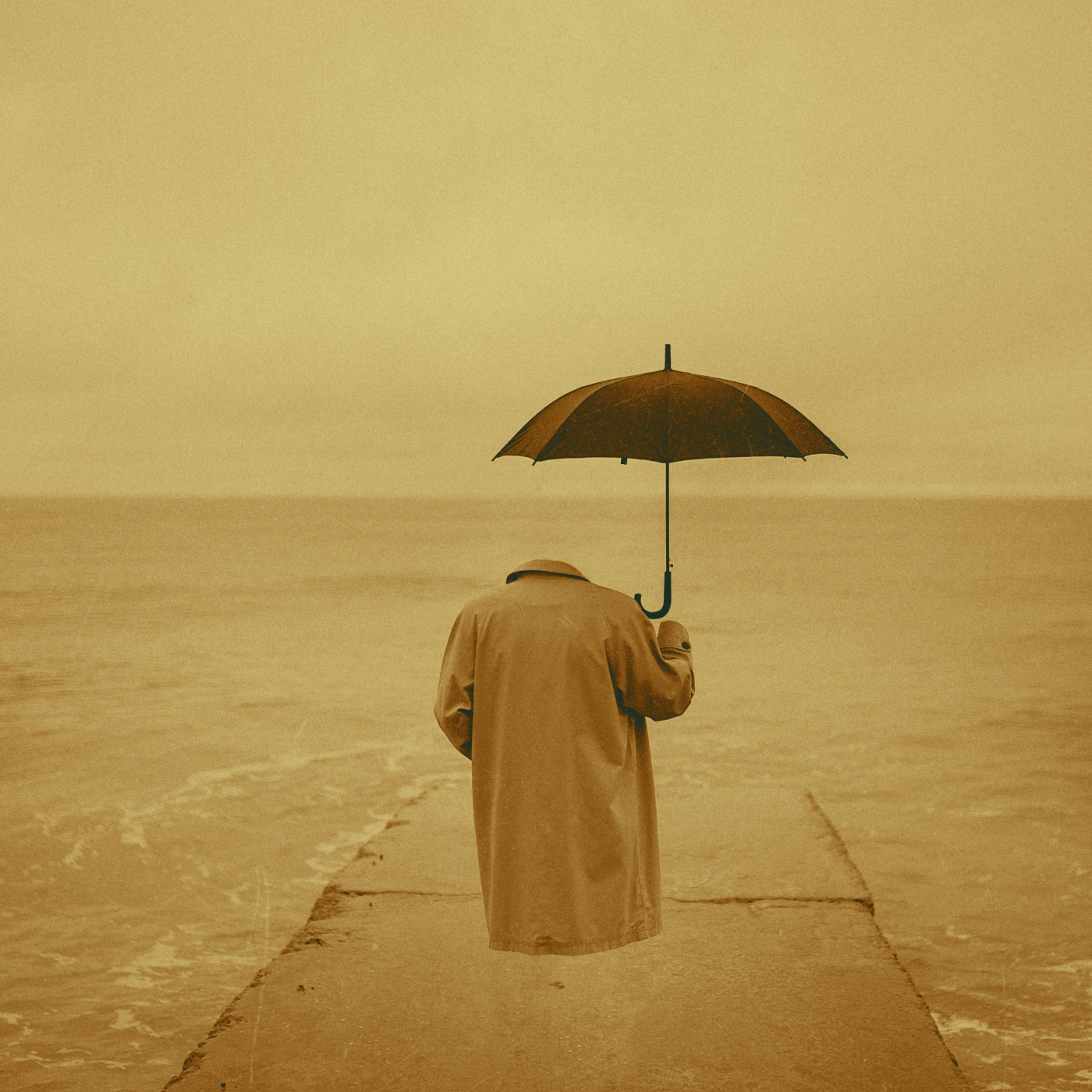 An empty raincoat and open umbrella floating as if occupied at the end of a stone pier