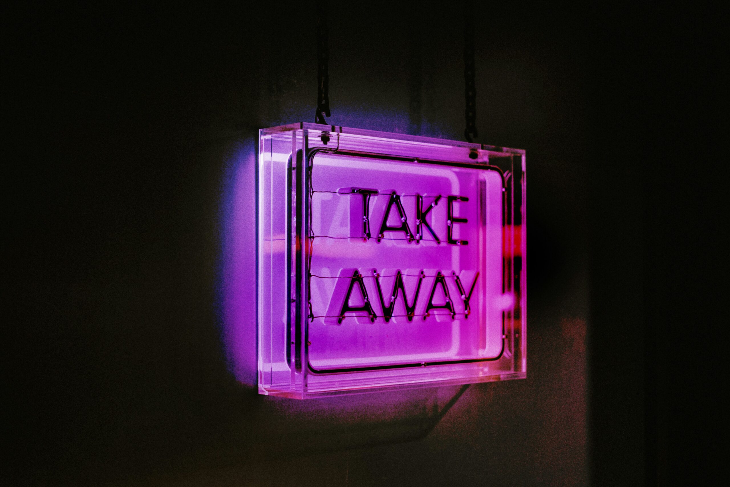 A purple neon take away sign