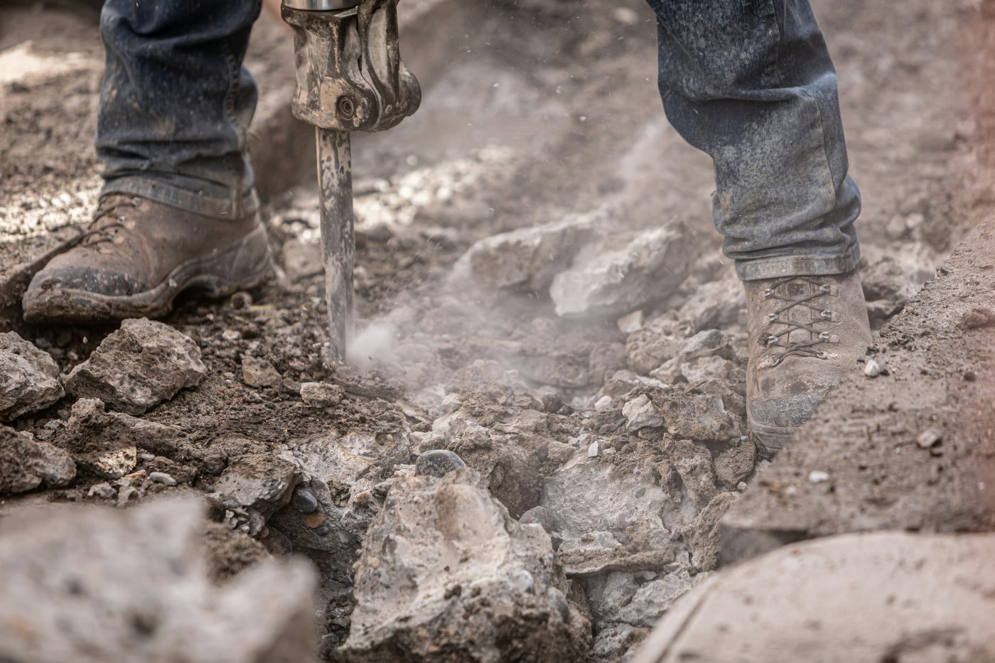 A worker using a jack hammer