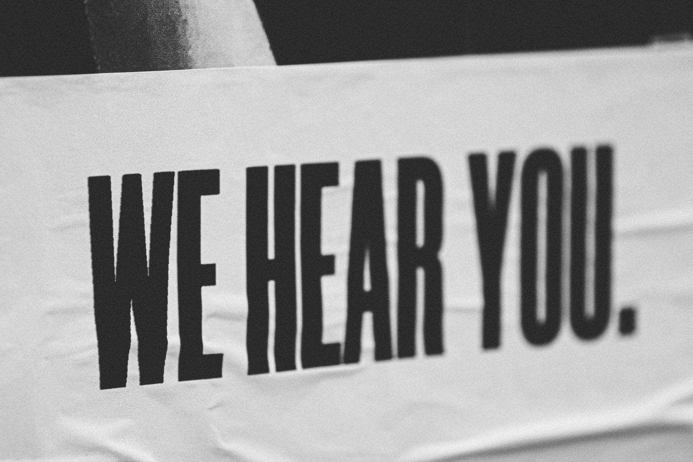 A sign that reads We Hear You