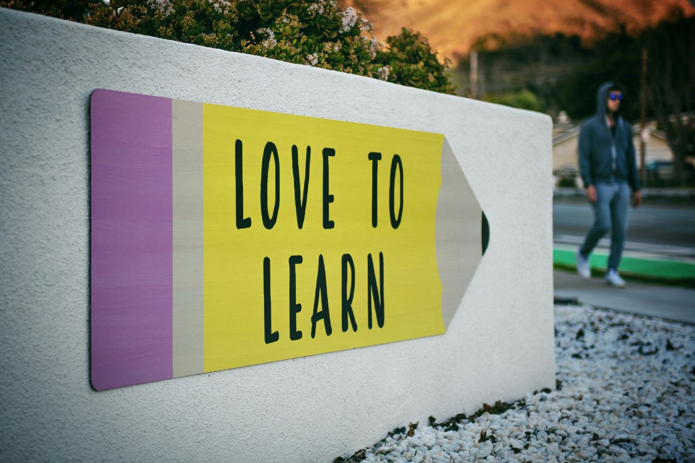 A pencil shaped sign with Love To Learn on it
