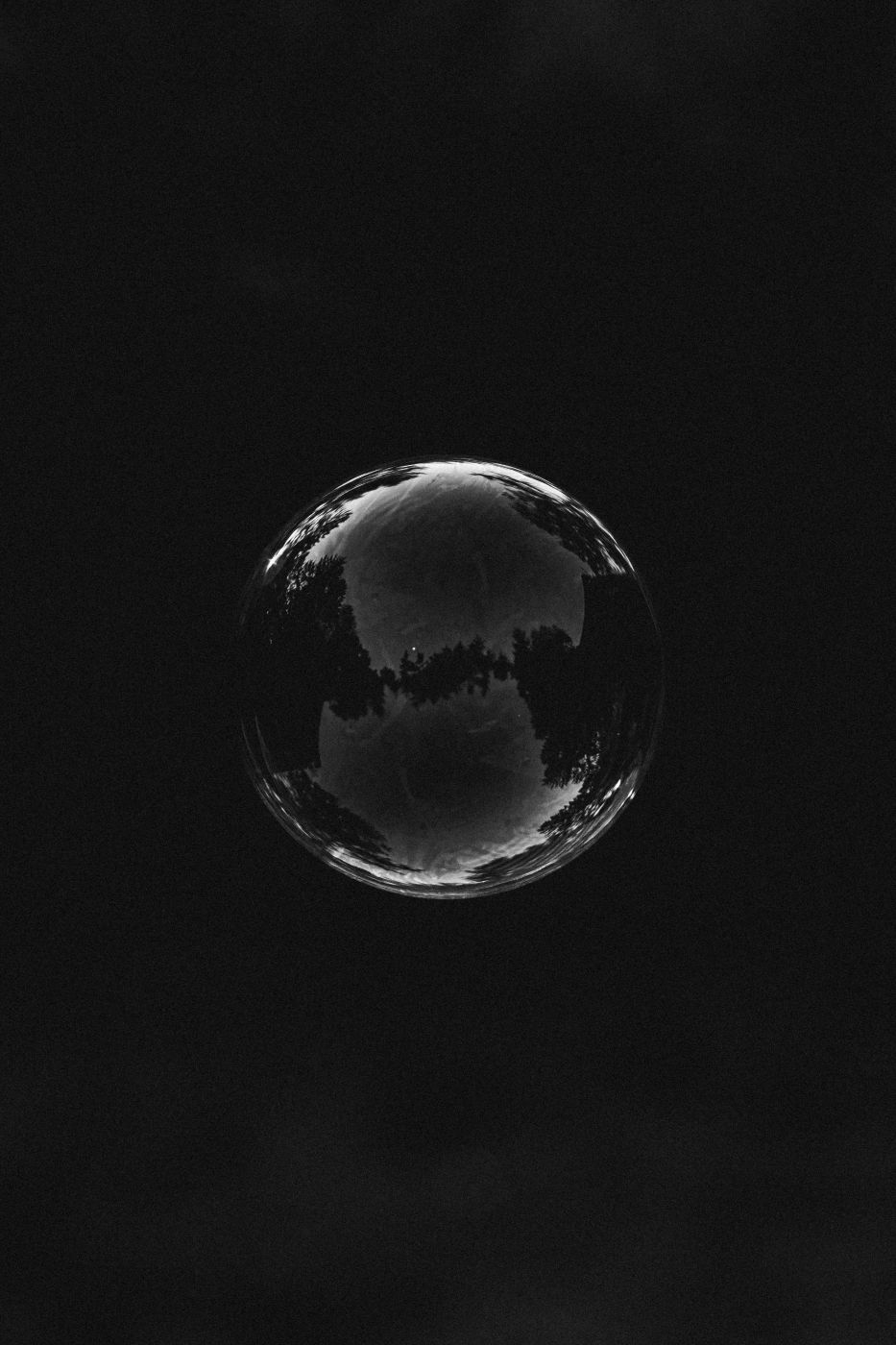 A single bubble floating in darkness