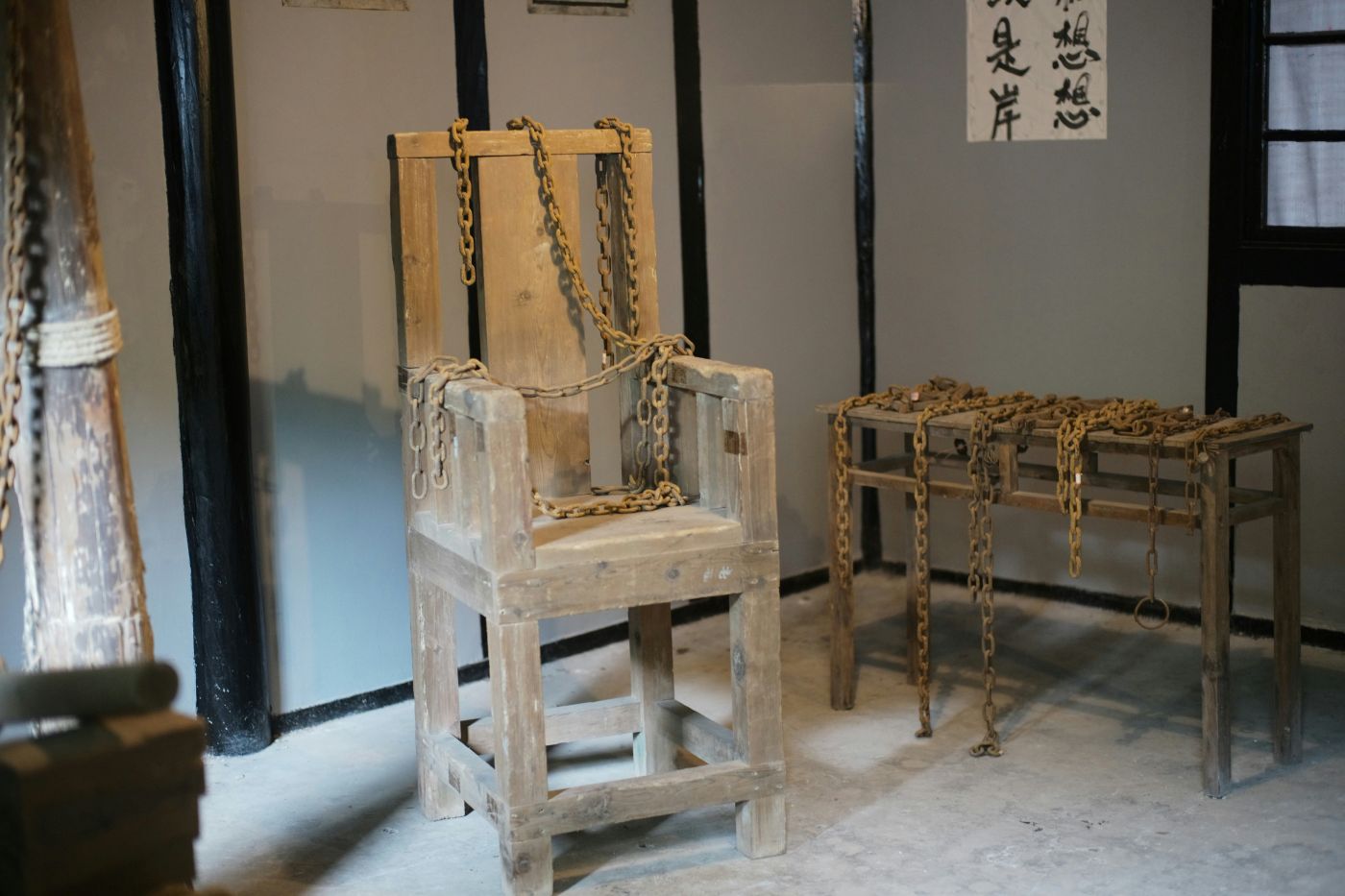 An antique wooded chair with chains